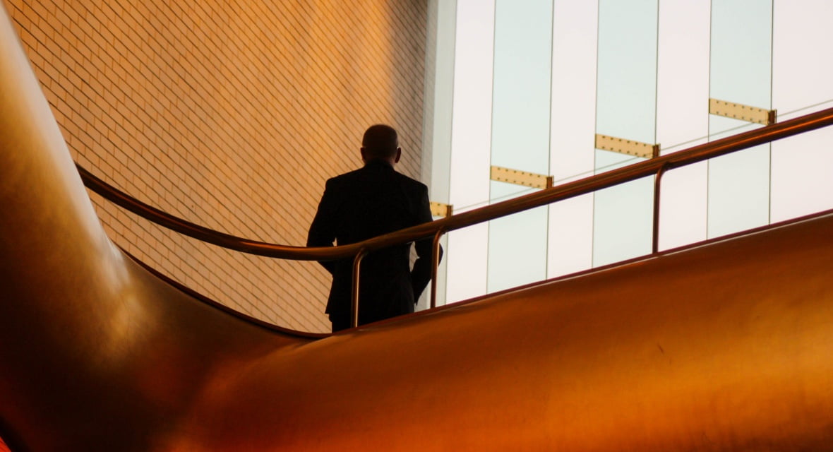 Man Standing on Balcony